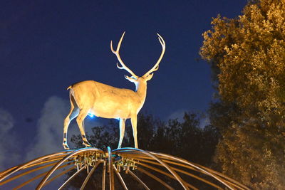 Low angle view of deer against sky