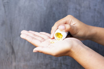 Cropped hand of person holding pills