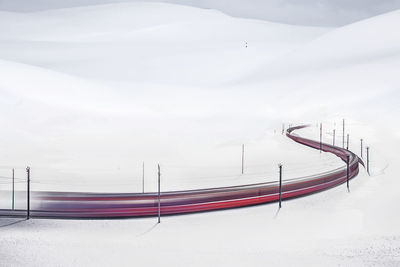 Snow covered field against sky