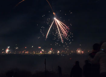 Low angle view of firework display at night