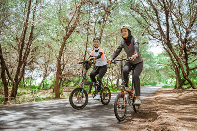 Side view of man riding bicycle on road