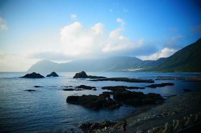 Scenic view of sea against cloudy sky