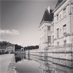 Reflection of buildings in lake against sky