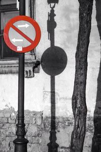 Road sign against sky in city