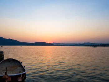Scenic view of lake against clear sky during sunset