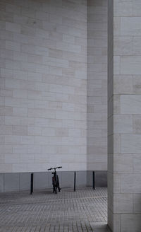 Rear view of a bike standing by wall