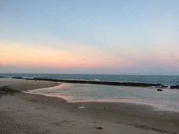 Scenic view of beach against sky during sunset