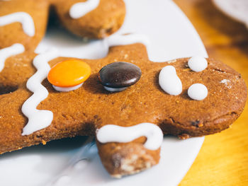 Close-up of gingerbread man served on table