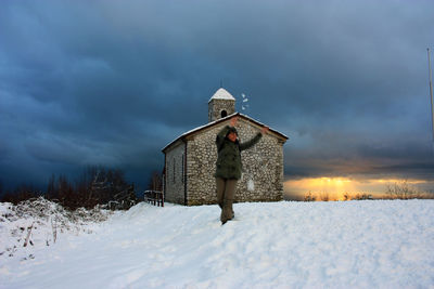 Built structure on snow covered land against sky