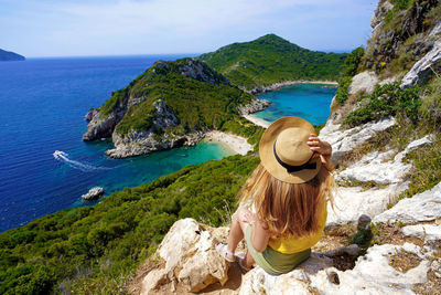 Traveler girl enjoying landscape from porto timoni viewpoint in corfu, greece