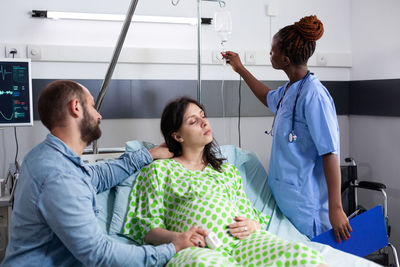 High angle view of doctor examining patient in clinic