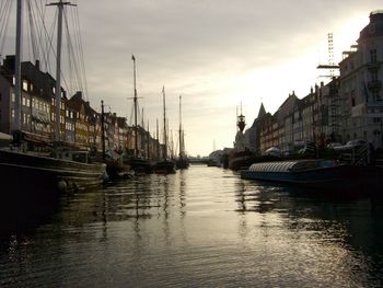 Boats in river with buildings in background