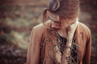 Portrait of young woman looking away outdoors