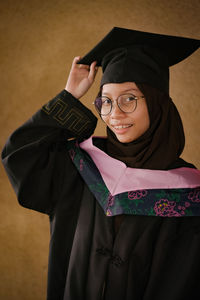 Portrait of woman wearing graduation gown