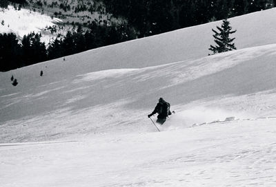 Person skiing on snow covered mountain