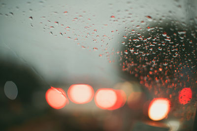 Close-up of wet glass window during rainy season