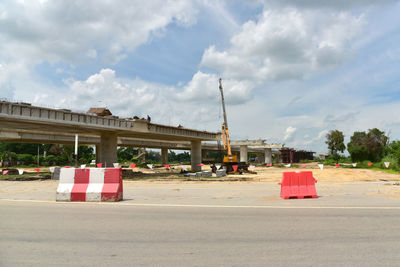 Traffic on road against sky in city