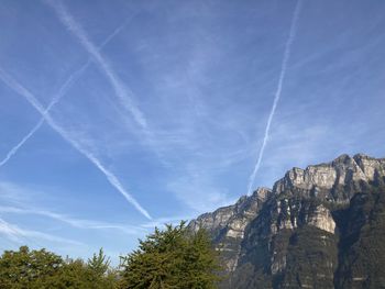 Low angle view of vapor trail against blue sky