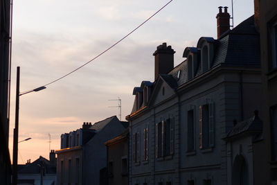 Low angle view of buildings against sky at dusk