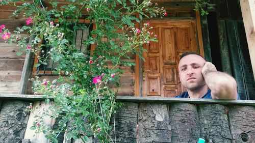 Portrait of woman against flowering plants