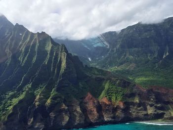 Scenic view of mountains against cloudy sky at kalalau valley