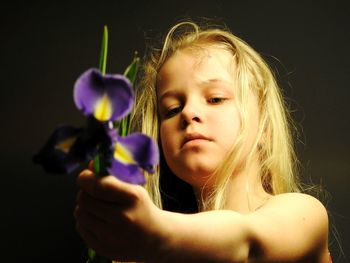 Close-up of girl holding purple flowers