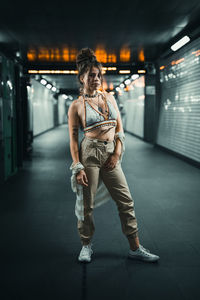 Full length of woman standing in illuminated building