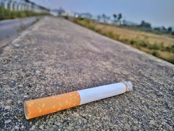 Close-up of cigarette on road