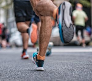 Low section of people walking on road