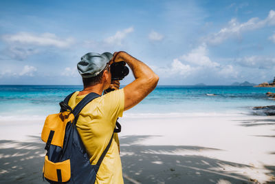 Rear view of man standing on beach