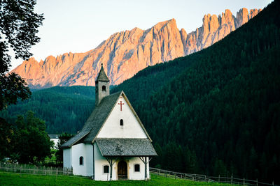 Scenic view of houses and mountains against sky