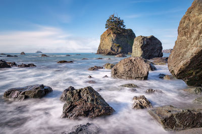 Panoramic view of rocks in sea against sky