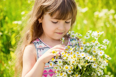 Close-up of young woman picking flowers