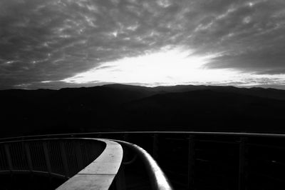 Road by mountain against sky