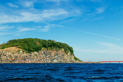 Scenic view of sea against blue sky