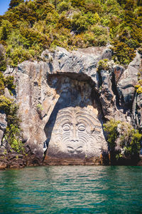 Graffiti on rock by water