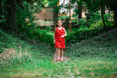 Portrait of smiling boy running on grass