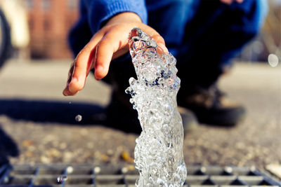 Close-up of human hand holding fountain