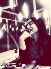 Portrait of a smiling young woman looking away