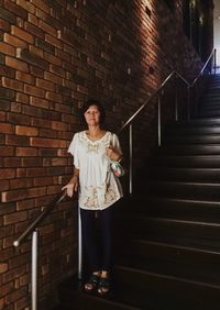 Portrait of senior woman standing on steps