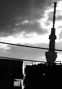 Low angle view of building against cloudy sky