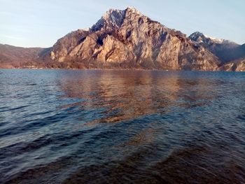 Scenic view of sea and mountains against sky