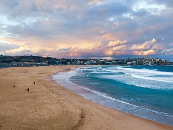 Scenic view of beach against sky during sunset