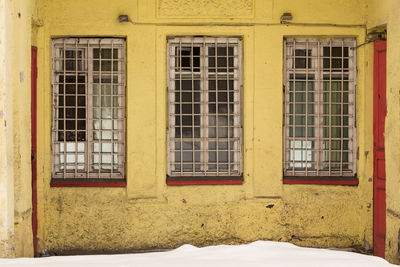 Close-up of snow covered window of building