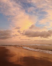 Scenic view of beach against sky during sunset