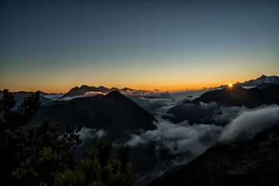 Scenic view of mountains against sky at sunset