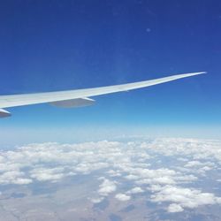 Aerial view of airplane flying in sky