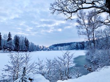 Scenic view of frozen lake against sky during winter