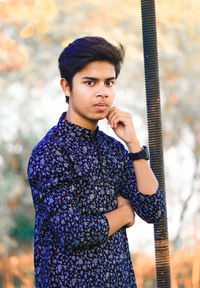 Portrait of young man standing outdoors