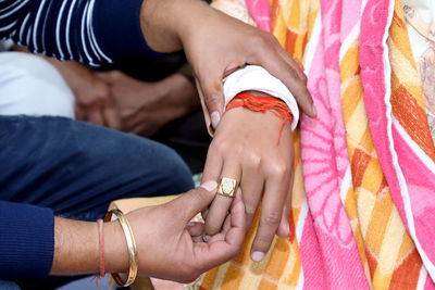 Midsection of couple holding hands